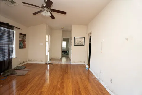 a view of empty room with wooden floor
