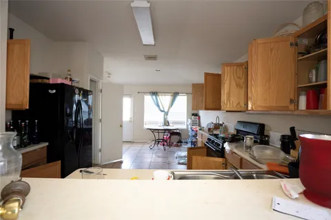 a kitchen with a refrigerator and a sink