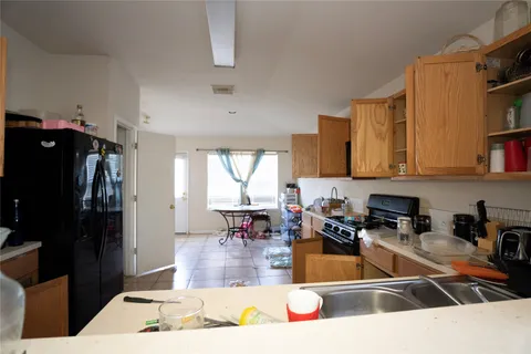 a kitchen with stainless steel appliances kitchen island granite countertop a sink and cabinets