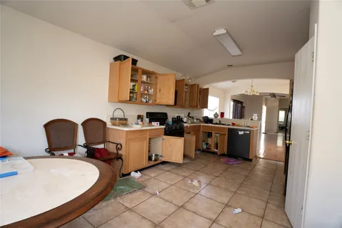 a kitchen with kitchen island granite countertop a sink cabinets and stainless steel appliances