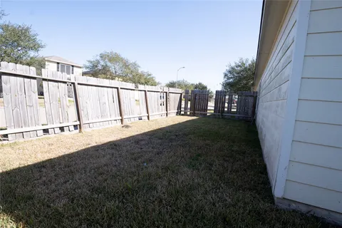 a view of a pathway of a house with wooden fence