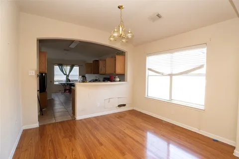 a view of a room with a window and chandelier