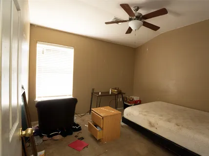 a bedroom with a bed and a desk