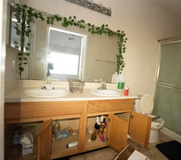 a bathroom with a sink mirror vanity and toilet