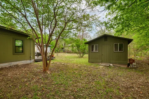 a house that has a tree in front of it