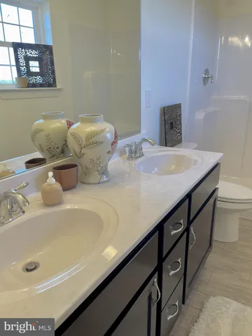 a bathroom with a double vanity sink and a mirror