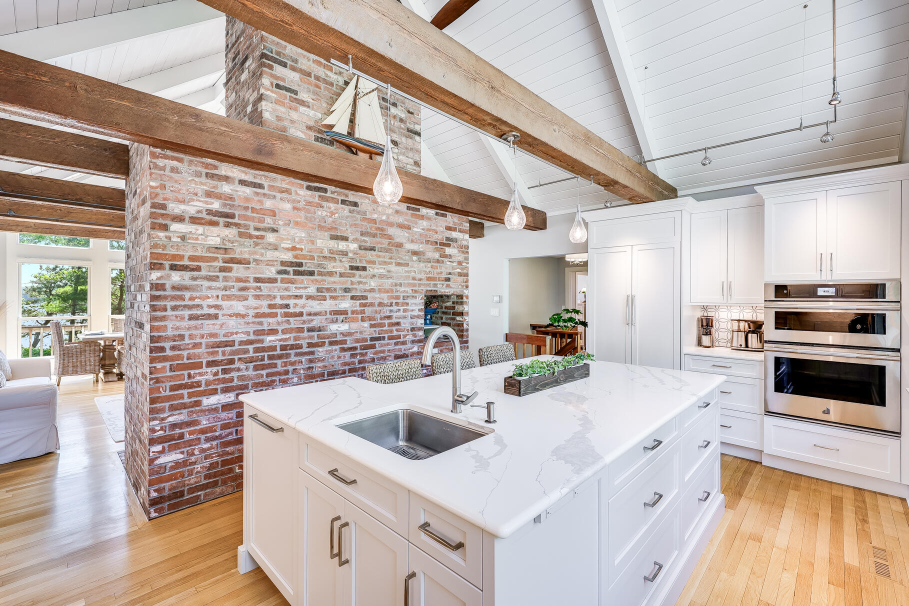 108 Bay Road Cotuit, MA 02635 - Photo 15 of 39 a kitchen with a sink cabinets a counter top space and stainless steel appliances