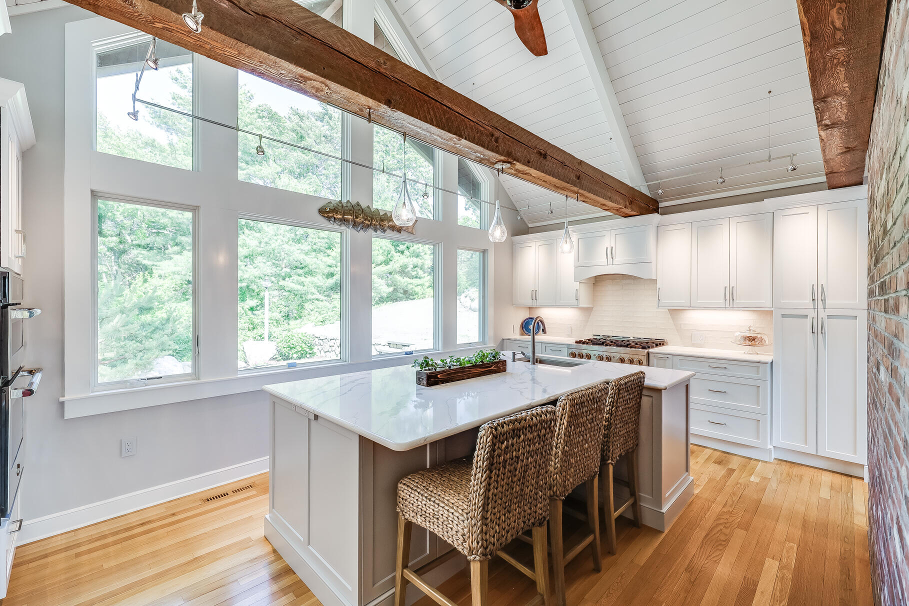 108 Bay Road Cotuit, MA 02635 - Photo 17 of 39 a kitchen with granite countertop a stove a sink and wooden floor