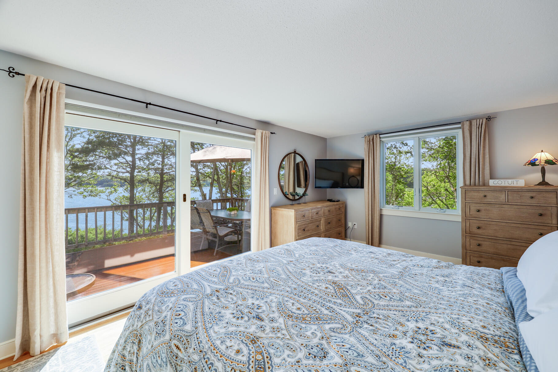 108 Bay Road Cotuit, MA 02635 - Photo 20 of 39 a bedroom with a bed dresser and a large window with outer view