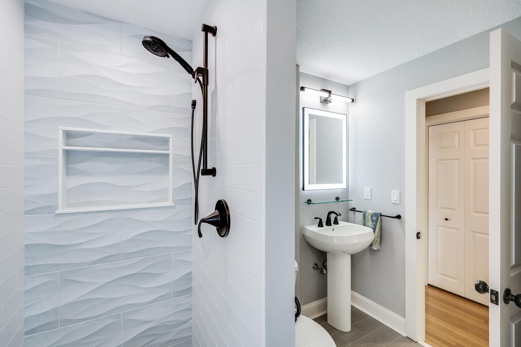 108 Bay Road Cotuit, MA 02635 - Photo 27 of 39 a bathroom with a sink a mirror and shower