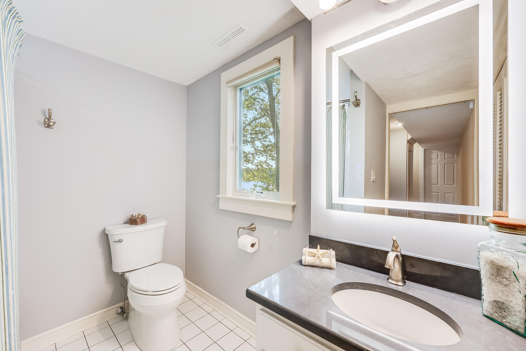 108 Bay Road Cotuit, MA 02635 - Photo 32 of 39 a bathroom with a granite countertop toilet sink and mirror