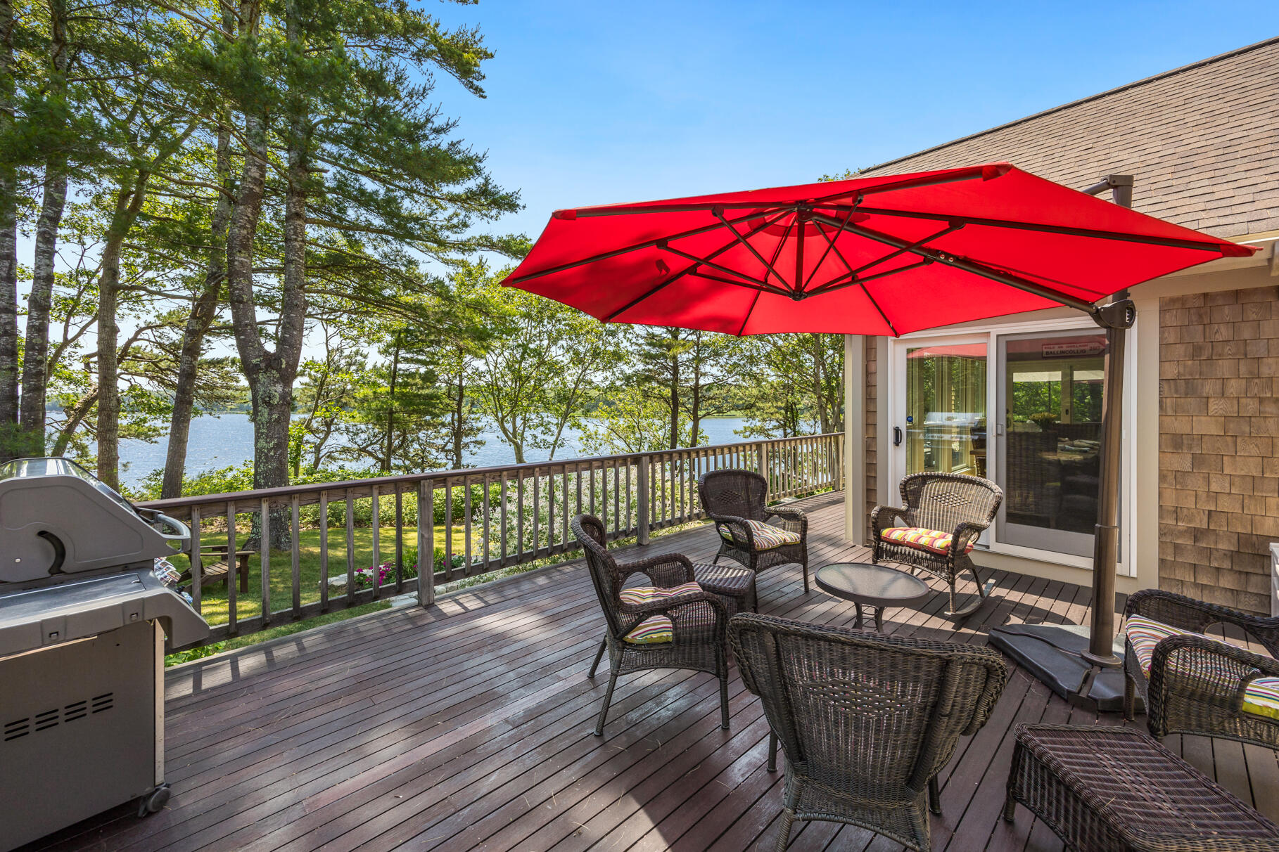 108 Bay Road Cotuit, MA 02635 - Photo 5 of 39 an outdoor sitting area with furniture and wooden floor