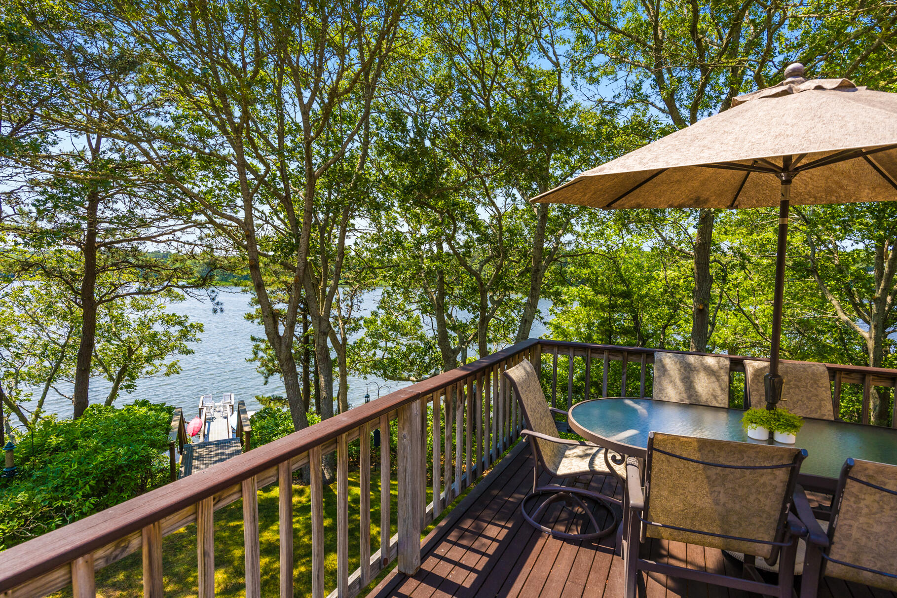 108 Bay Road Cotuit, MA 02635 - Photo 6 of 39 a balcony with wooden floor and outdoor seating