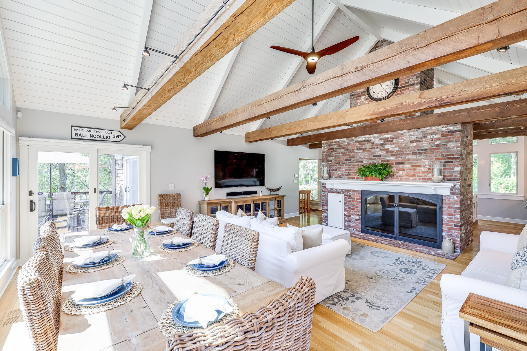 108 Bay Road Cotuit, MA 02635 - Photo 9 of 39 a living room with furniture a fireplace and a flat screen tv