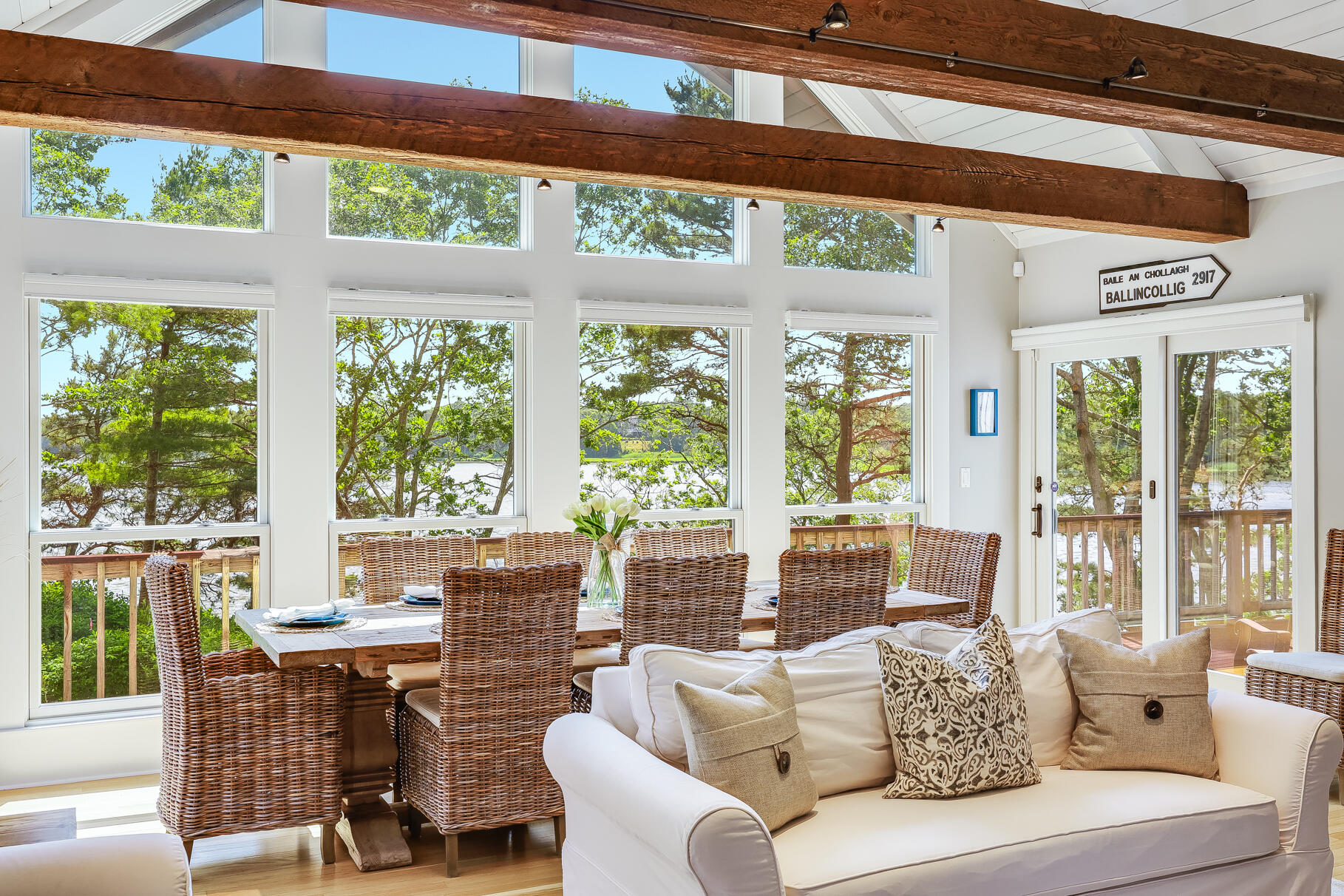 108 Bay Road Cotuit, MA 02635 - Photo 10 of 39 a living room with furniture and floor to ceiling windows