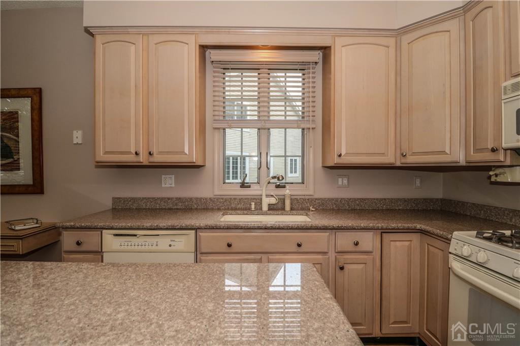 33 Whitehall Road Monroe Township, NJ 08831 - Photo 11 of 25 a kitchen with stainless steel appliances granite countertop a sink a stove and a microwave