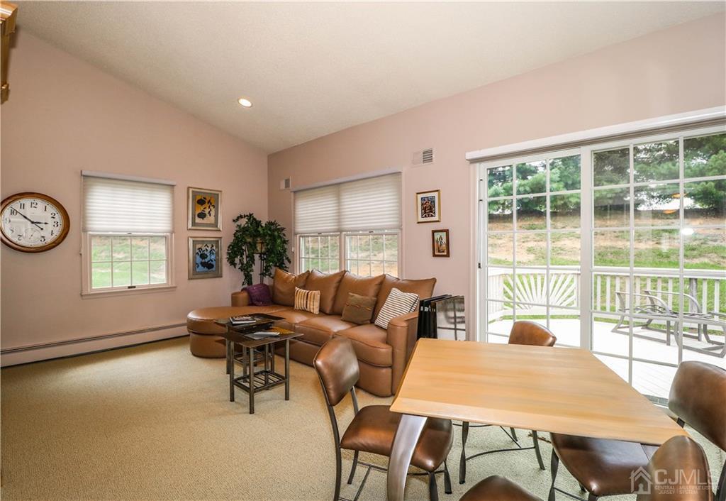 33 Whitehall Road Monroe Township, NJ 08831 - Photo 17 of 25 a living room with furniture a large window and a table