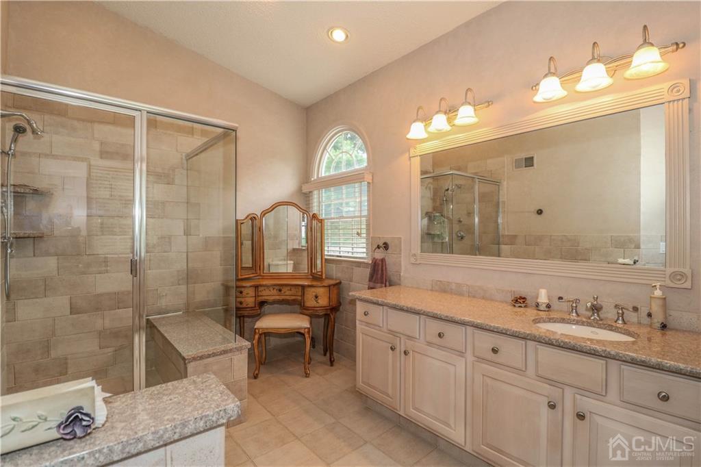 33 Whitehall Road Monroe Township, NJ 08831 - Photo 21 of 25 a spacious bathroom with double vanity a sink a mirror and a shower