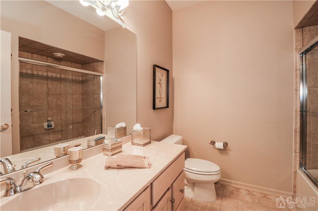 33 Whitehall Road Monroe Township, NJ 08831 - Photo 24 of 25 a bathroom with a granite countertop sink toilet and shower