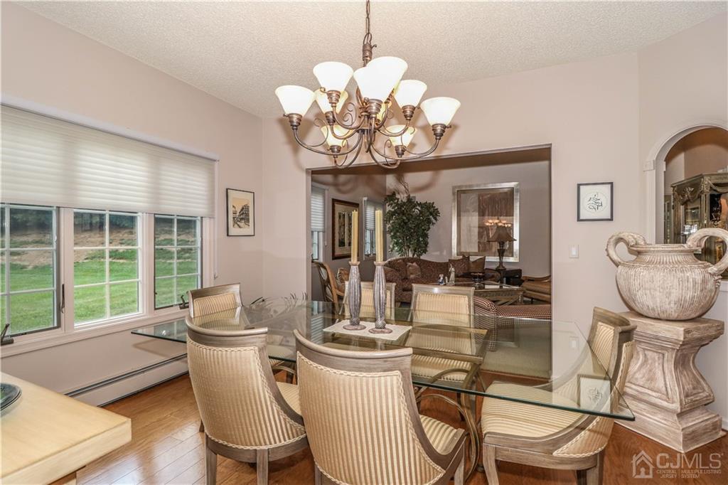 33 Whitehall Road Monroe Township, NJ 08831 - Photo 9 of 25 a view of a dining room with furniture a chandelier and wooden floor