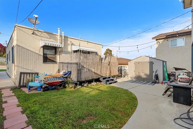 a backyard of a house with yard and outdoor seating