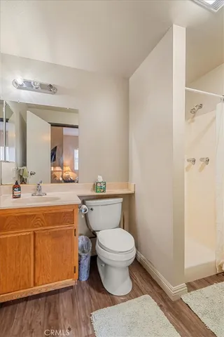 a bathroom with a granite countertop toilet a sink and a mirror