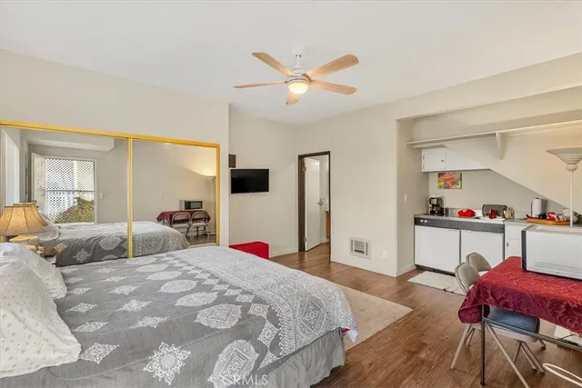 a bedroom with a bed and a view of kitchen
