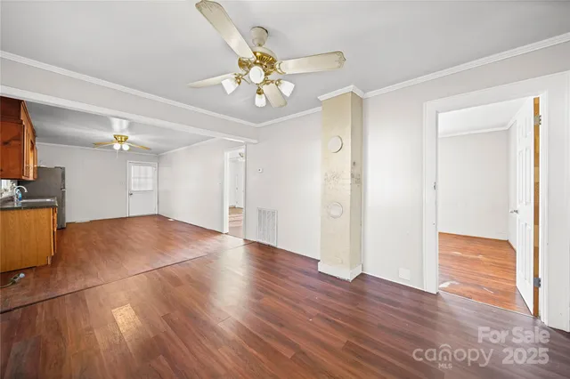 a view of an empty room and wooden floor