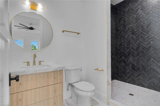 a bathroom with a sink and mirror with toilet