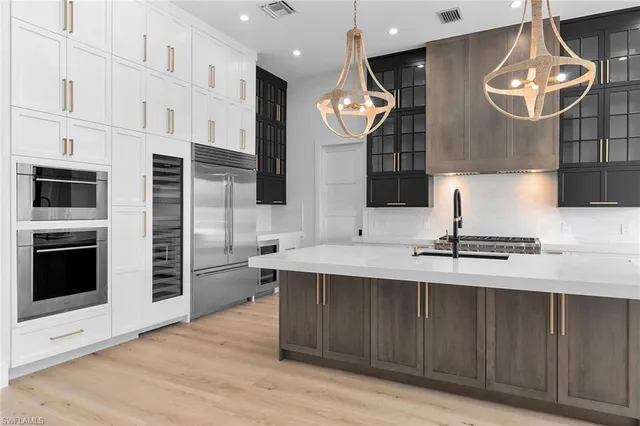 a kitchen with cabinets and stainless steel appliances