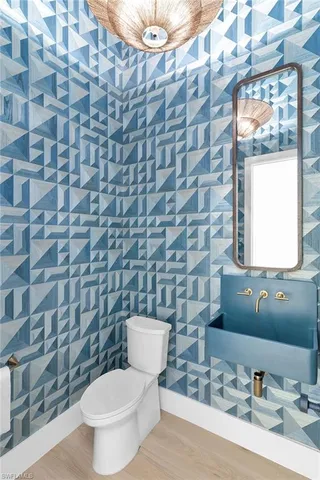 a bathroom with a toilet a sink and mirror