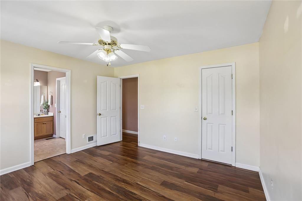 9720 Poole Road Villa Rica, GA 30180 - Photo 16 of 40 a view of a room with wooden floor and a ceiling fan