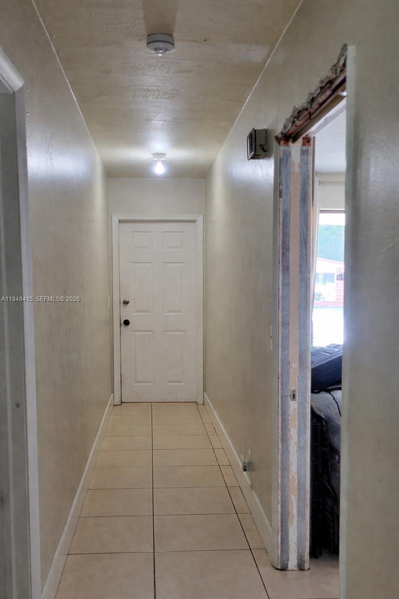 508 Southwest 8th Street Hallandale Beach, FL 33009 - Photo 12 of 12 hallway separates bedrooms from living areas with firewall and pocket door