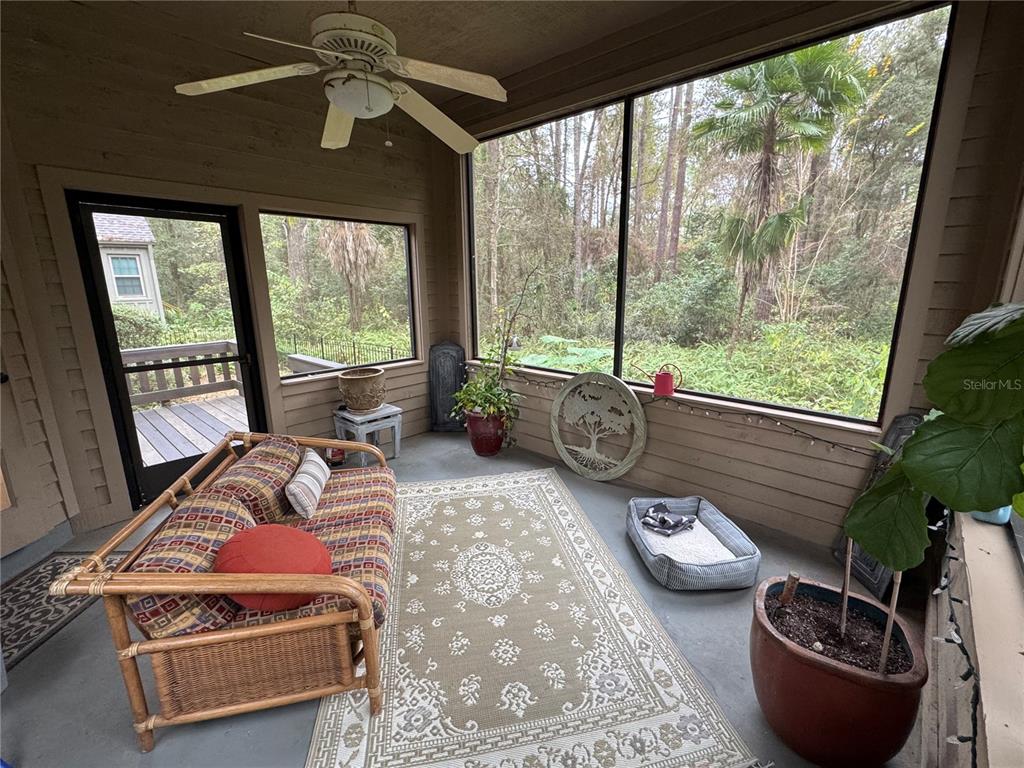 4623 Southwest 83 Drive Gainesville, FL 32608 - Photo 19 of 29 a living room with furniture and a floor to ceiling window
