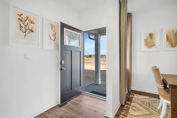 a view of a hallway with elevator and glass door