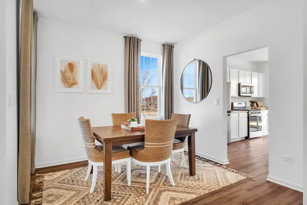 a dining room with furniture and window