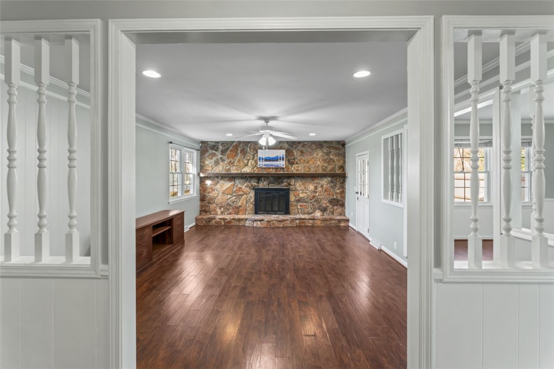 304 Stonehaven Drive Anderson, SC 29625 - Photo 14 of 19 A spacious living area showcases rich hardwood flooring and an impressive stone fireplace.