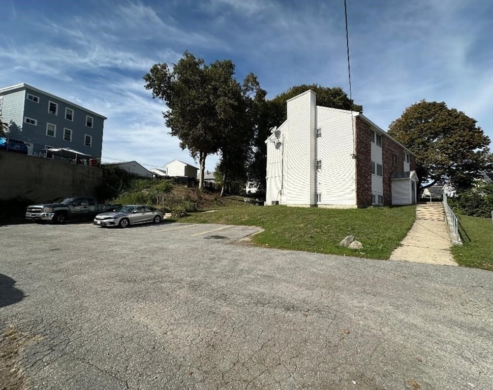 5 Lenox Street, Unit 2 Lowell, MA 01852 - Photo 2 of 12 a view of a street with houses