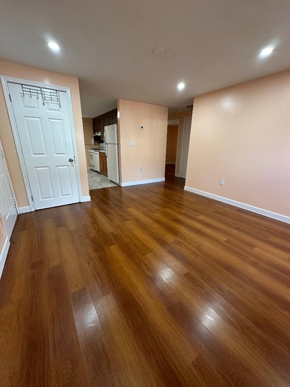 5 Lenox Street, Unit 2 Lowell, MA 01852 - Photo 3 of 12 a view of an empty room with wooden floor and a window