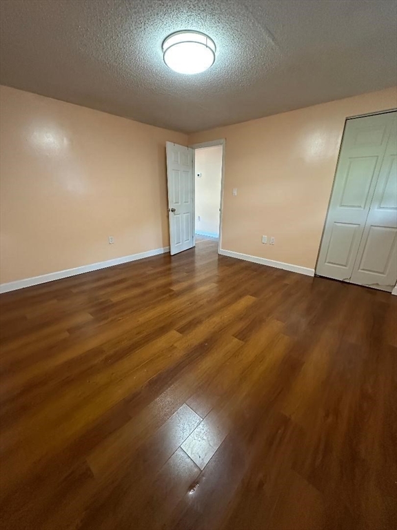 5 Lenox Street, Unit 2 Lowell, MA 01852 - Photo 4 of 12 an empty room with wooden floor and windows