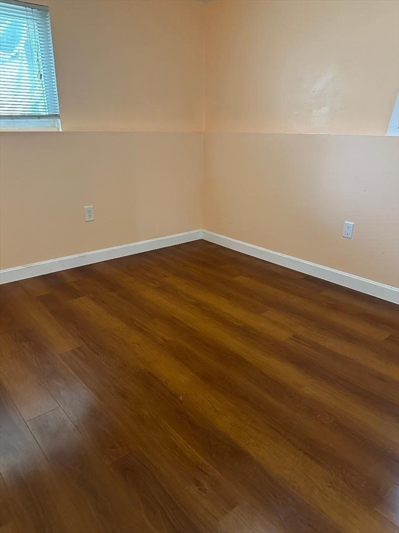 5 Lenox Street, Unit 2 Lowell, MA 01852 - Photo 6 of 12 a view of an empty room with wooden floor and cabinets