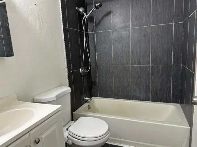 a bathroom with a toilet a sink and bathtub