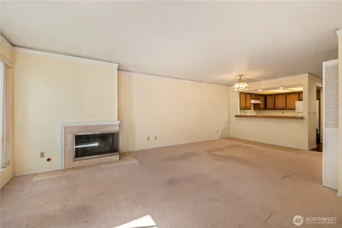 a view of a livingroom with wooden floor and a fireplace
