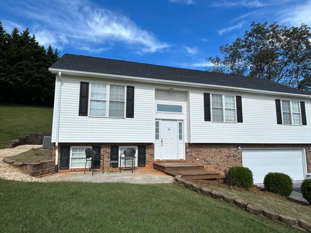 a living room with furniture a large window and a flat screen tv