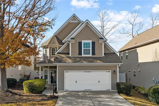 a view of a white house next to a yard