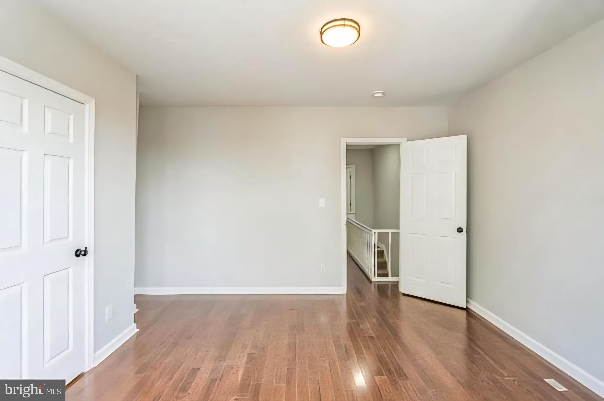 1637 South Ithan Street Philadelphia, PA 19143 - Photo 6 of 8 wooden floor in an empty room with a window