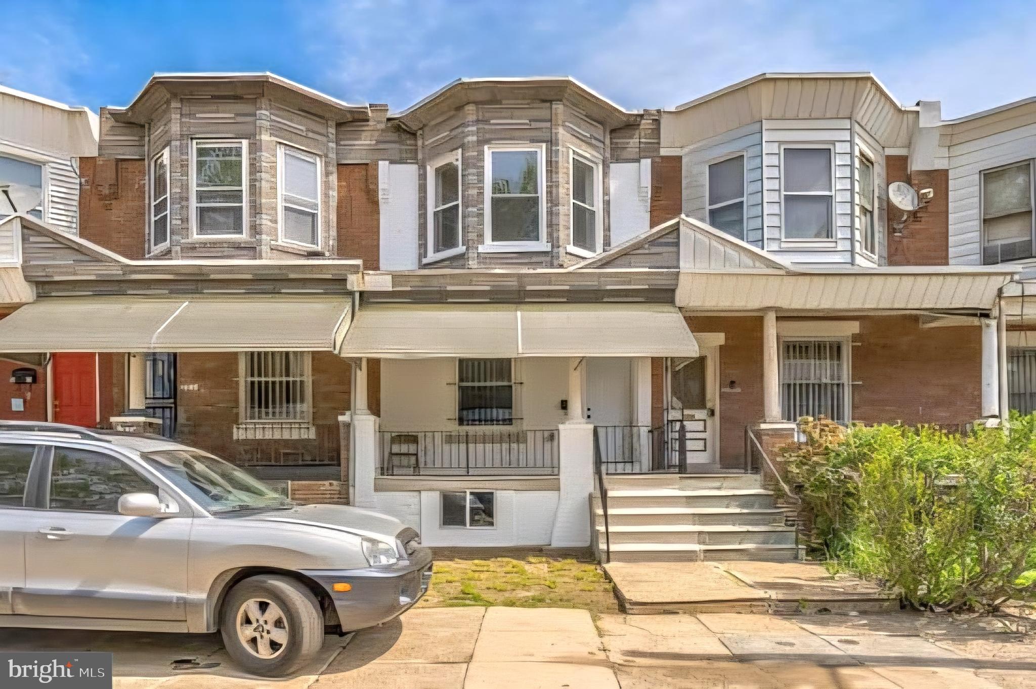 1637 South Ithan Street Philadelphia, PA 19143 - Photo 7 of 8 a front view of a residential apartment building with a yard