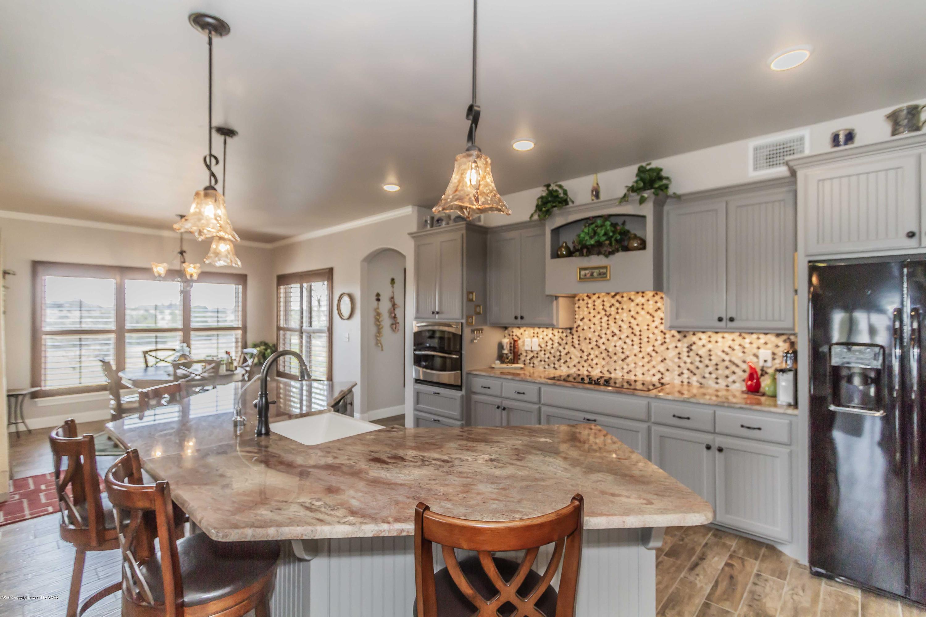 305 Mourning Dove Road Canyon, TX 79015 - Photo 21 of 65 a kitchen with stainless steel appliances granite countertop a stove and refrigerator