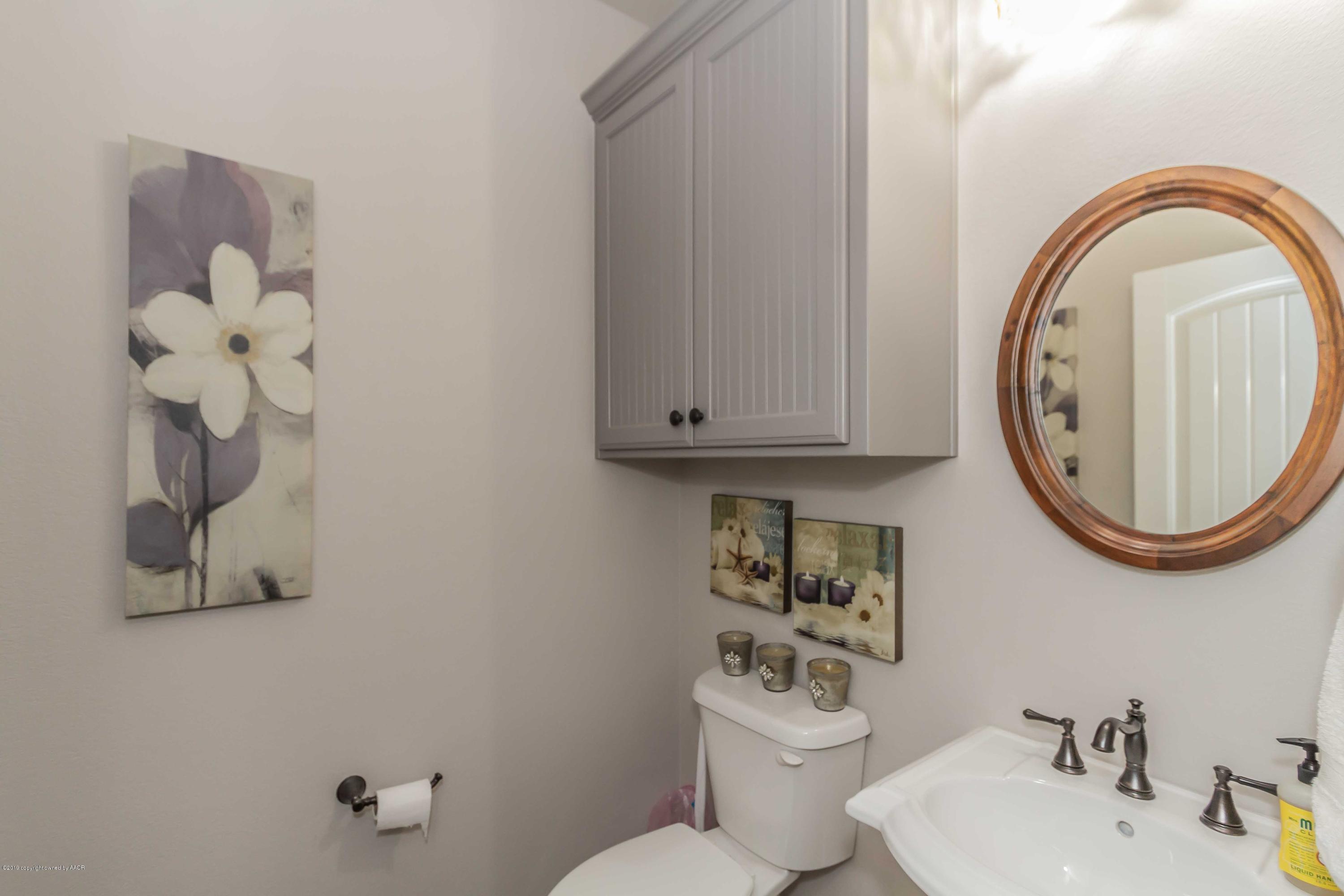 305 Mourning Dove Road Canyon, TX 79015 - Photo 23 of 65 a bathroom with a blue sink and a mirror