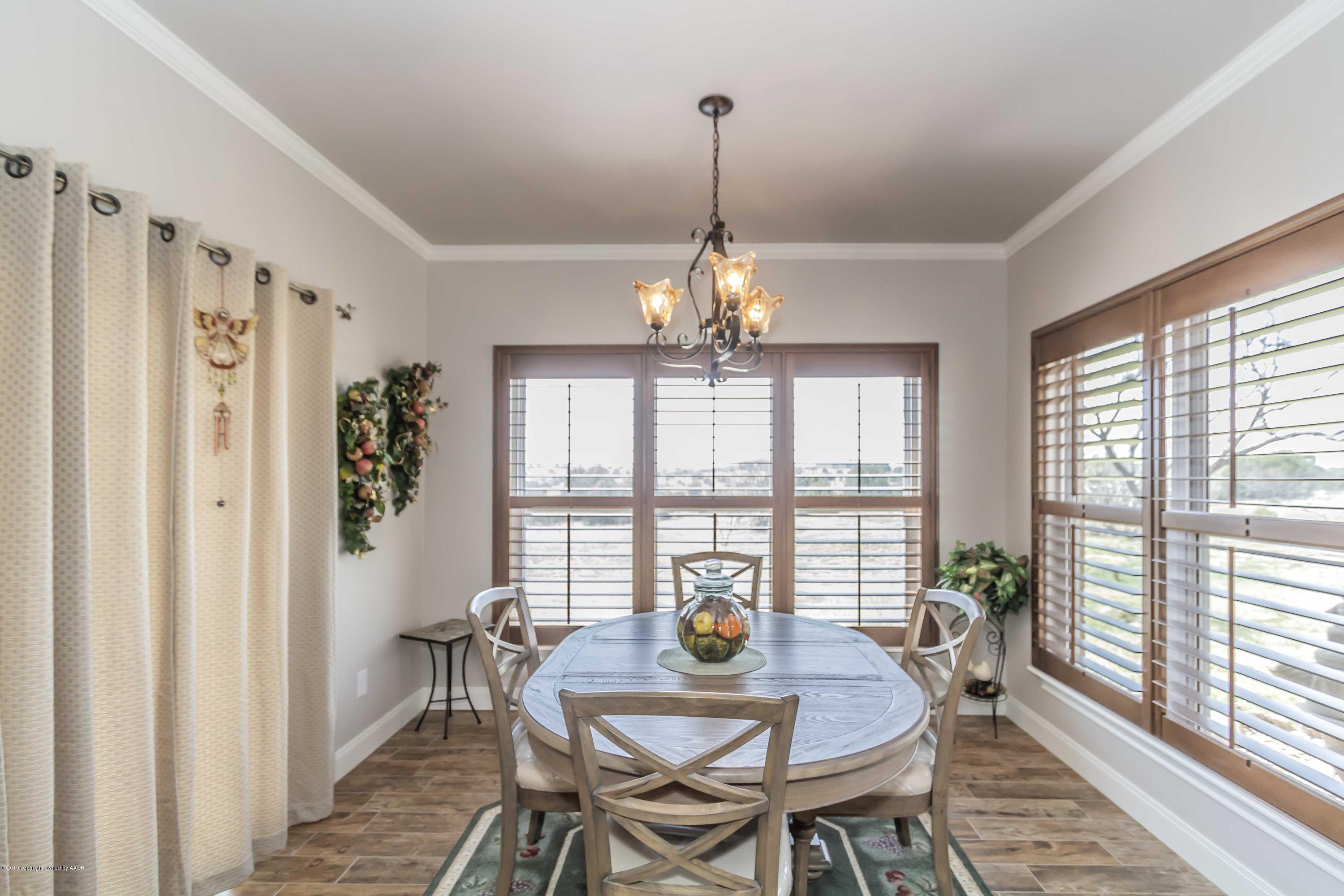 305 Mourning Dove Road Canyon, TX 79015 - Photo 24 of 65 a view of a dining room with furniture wooden floor and chandelier